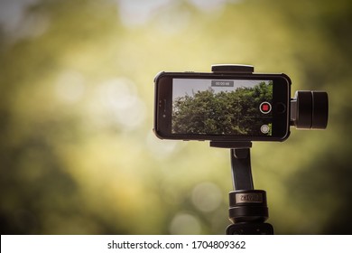 Ayutthaya, Thailand - APR 12 2020 : Mobile Phone IPhone 8 Is Filming A Documentary Movie About Trees And Nature Using Zhiyun Smooth 4 Mobile Gimbal In Order To Shoot Smooth, Fast Professional Videos.