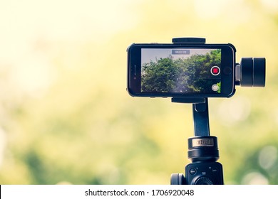 Ayutthaya, Thailand - APR 12 2020 : Mobile Phone IPhone 8 Is Filming A Documentary Movie About Trees And Nature Using Zhiyun Smooth 4 Mobile Gimbal In Order To Shoot Smooth, Fast Professional Videos.