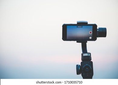 Ayutthaya, Thailand - APR 12 2020 : Mobile Phone IPhone 8 Is Filming A Documentary Movie About Sky And Nature Using Zhiyun Smooth 4 Mobile Gimbal In Order To Shoot Smooth, Fast Professional Videos.