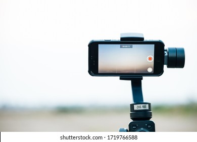 Ayutthaya, Thailand - APR 12 2020 : Mobile Phone IPhone 8 Is Filming A Documentary Movie About Sky And Nature Using Zhiyun Smooth 4 Mobile Gimbal In Order To Shoot Smooth, Fast Professional Videos.