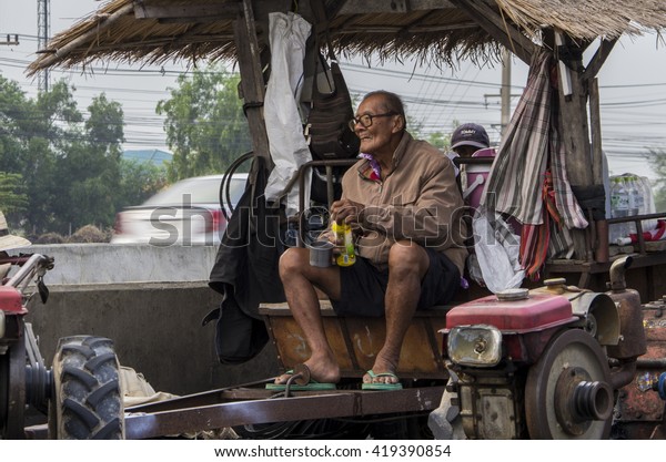 Ayutthaya, Thailand - Feb 20, 2014: The old\
man - Thai rice farmer during the convoy march on Asia road (AH1)\
to demand for unpaid subsidy for pledged\
rice.