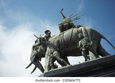 Ayutthaya, Thailand - July 28, 2022: Queen Suriyothai Monument, That Depicts A Fierce Looking King Maha Chakkraphat On His War Elephant, Surrounded By Siamese Soldiers With Clouds And Blue Sky.