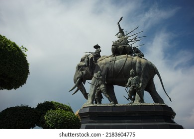 Ayutthaya, Thailand - July 28, 2022: Queen Suriyothai Monument, That Depicts A Fierce Looking King Maha Chakkraphat On His War Elephant, Surrounded By Siamese Soldiers With Clouds And Blue Sky.