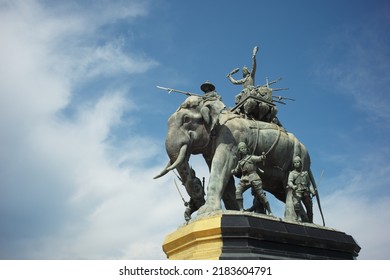 Ayutthaya, Thailand - July 28, 2022: Queen Suriyothai Monument, That Depicts A Fierce Looking King Maha Chakkraphat On His War Elephant, Surrounded By Siamese Soldiers With Clouds And Blue Sky.