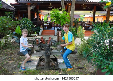 Ayutthaya/Thailand - July 14, 2018: Child And Woman Playing On A See Saw At A Resort.