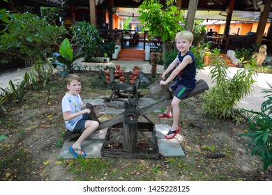 Ayutthaya/Thailand - July 14, 2018: Children Playing On A See Saw At A Resort.