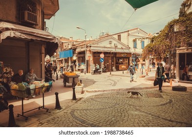 AYVALIK, TURKEY: Street Life With Walking People Past Local Shops And Market On Bright Day In Ancient Turkish City On 27 April, 2021. Ayvalik Is A Seaside Town On Northwestern Aegean Coast.