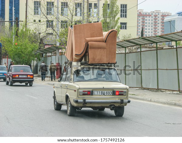 Azerbaijan,\
Baku - April 30, 2007: Classic soviet vintage sedan car LADA VAZ\
2103 with trunk that is overload by\
furniture