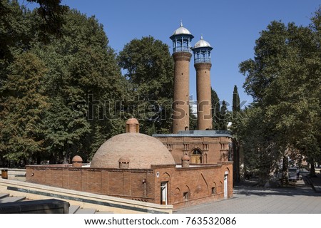 Azerbaijan, Ganja: Minarets of Juma Mosque of Ganja or Friday Mosque of Ganja with blue sky. The famous mosque is also often called Shah Abbas Mosque and was built in 1606 - concept religion travel.