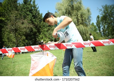 Azerbaijan, Ismayilli 26.08.2016: Outdoor Orienteering Check Point Activity . Line At An Orienteering . Person Racing To An Orienteering Check Point, Put The Finger Chip Into Digital Check Box