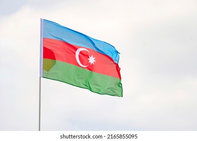 Azerbaijan national flag waving in beautiful clouds sky