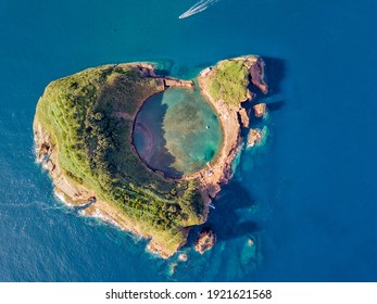 Azores aerial panoramic view. Top view of Islet of Vila Franca do Campo. Crater of an old underwater volcano. Sao Miguel island, Azores, Portugal. Heart carved by nature. Bird eye view.