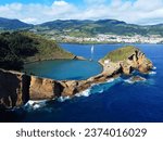 Azores aerial panoranic top view of Islet of Vila Franca do Campo. Sailboat in the ocean.  Crater of old volcano in ocean. San Miguel, Acores, Portugal. Travel concept.