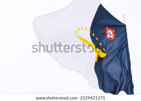 Azores Official Flag bouncing in the air on a windy day, São Miguel Island, Azores. Copy space.