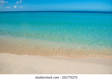 Azure turquoise calm sea, clear blue sky, sandy beach and flat horizon