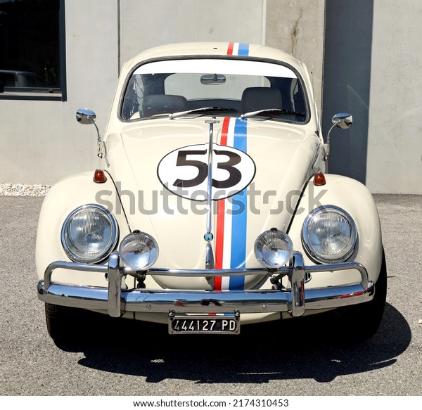Azzida, Italy. July, 2 2022.\
Convertible white Volkswagen Type 1 , known as beetle and  painted\
as Herbie of the film Love Bug, during a vintage car\
gathering