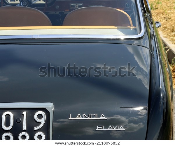 Azzida, Italy. July, 3 2021. Lancia Flavia logo\
on the back of the car during a vintage gathering. It is an italian\
sports car of the Sixties\
