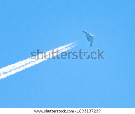 B2 Stealth Bomber flying at high altitude.  This is one of three that were flying together in a loose formation. This had to be strangest thing I've ever photographed. It was like seeing a UFO.