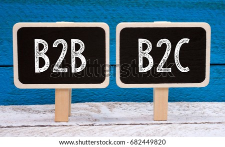B2B and B2C Business - two little chalkboards with text on blue wooden background