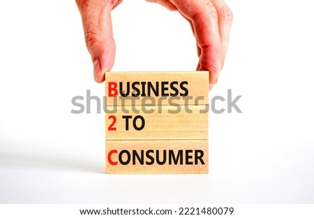 B2C business to consumer symbol. Concept words B2C business to consumer on wooden blocks on a beautiful white background. Businessman hand. Business and B2C business to consumer concept. Copy space.