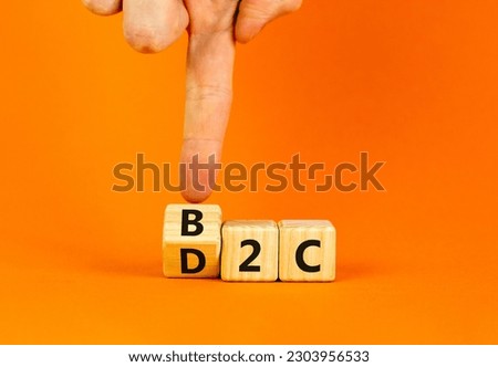 B2C or D2C symbol. Concept words B2C business to consumer D2C direct to consumer. Businessman hand. Beautiful orange background. B2C business to consumer D2C direct to consumer concept. Copy space.