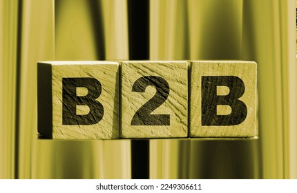 B2C letters on wooden cubes put on wooden table standing outdoors. Summer nature background. Business to Customer concept. Client oriented. - Shutterstock ID 2249306611
