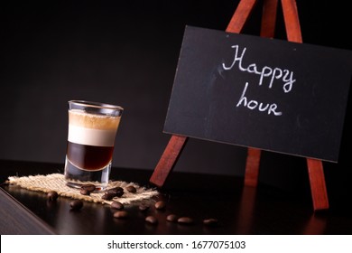 B-52 Layered Cocktail Shot On A Burlap Coaster Decorated With Fresh Roasted Coffee Beans Placed On A Bar Counter With Copy Space