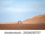 Bab, door, port, entry to Thousands Nights Desert Resort Wahiba Sands. Oman. Sand dunes, blue sky. February 8, 2024. 