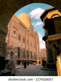 Bab Zuweila, CAIRO, EGYPT - December 19th, 2021: The view of the sultan al muayyad mosque which is behind the zuweila gate in winter there are some people selling and walking in winter clothes.