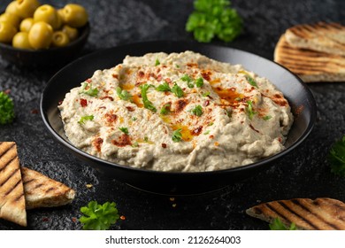 Baba ganoush dip made with grilled aubergine or eggplant, lemon juice, olive oil and tahini. Vegetarian starter food - Shutterstock ID 2126264003