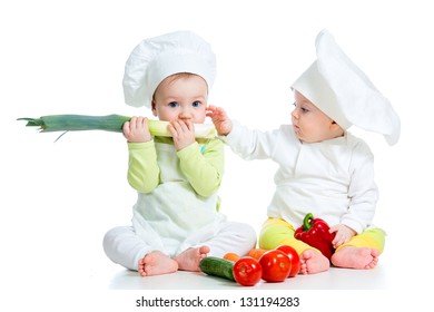 babies boy and girl wearing a chef hat with healthy  food vegetables