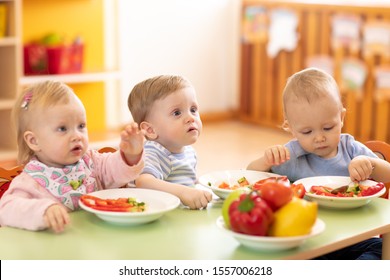 Babies Eating Healthy Food In Kindergarten Or Day Care Centre