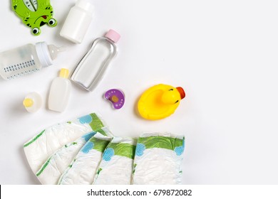 Babies Goods Diaper, Baby Powder, Cream, Shampoo, Oil On White Background With Copy Space. Top View Or Flat Lay.