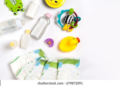 Babies Goods Diaper, Baby Powder, Cream, Shampoo, Oil On White Background With Copy Space. Top View Or Flat Lay.