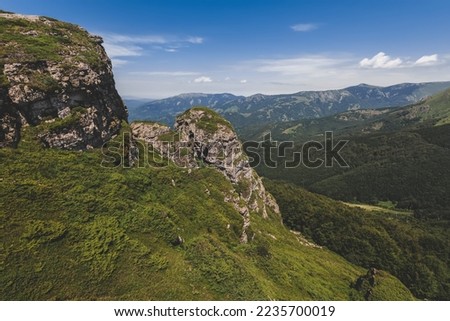 Babin Zub mountain peak in Old Mountain National park, nature preserve between Serbia and Bulgaria. Stara Planina beautiful landscape with mountains and rocks on a sunny summer day.