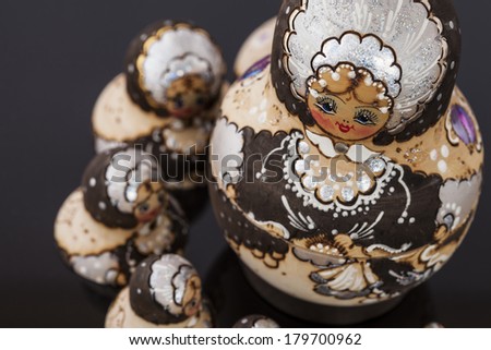 Babushkas in circle on black background. 