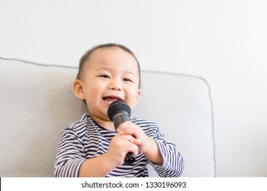 Baby 2 Years Old Boy Holding Microphone And Singing At Home.Baby Boy Relax Learn To Sing In Music Song Class.Family With Children And Art Education For Child. 
