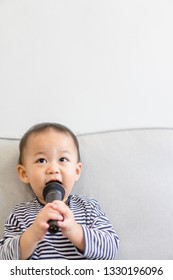 Baby 2 Years Old Boy Holding Microphone And Singing At Home.Baby Boy Relax Learn To Sing In Music Song Class.Family With Children And Art Education For Child. 