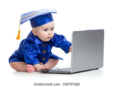 baby in academic dress works on laptop isolated
