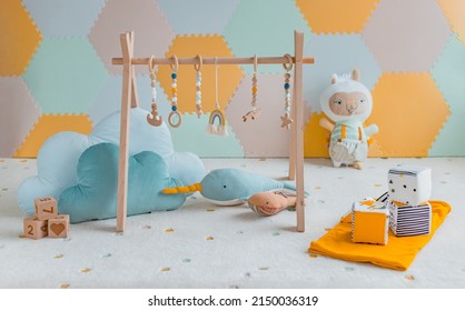 Baby Activity Gym Play Toys Hanging From Wooden Arch On Playmat In Nursery Or Playroom. Home Decoration Children Objects With Learning Cubes, Plush Cloud Toy, Whale Decor Banner