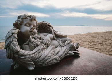 Baby Angel Statue Decorated On The Table By The Beach