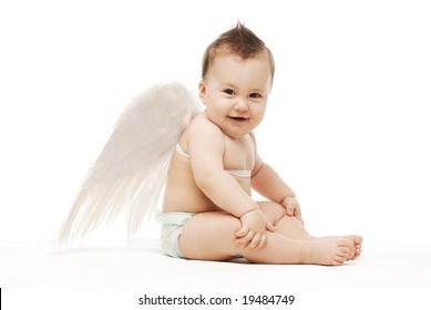Baby with angel wings sitting sideways laughing  holding his knees - Shutterstock ID 19484749