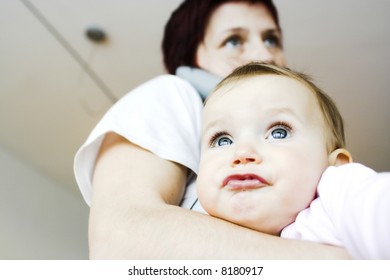 Baby  in mother´s arms - making funny faces