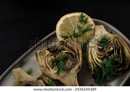baby artichoke cooked with olive oil and greens, popular springtime mediterranean kitchen starter food