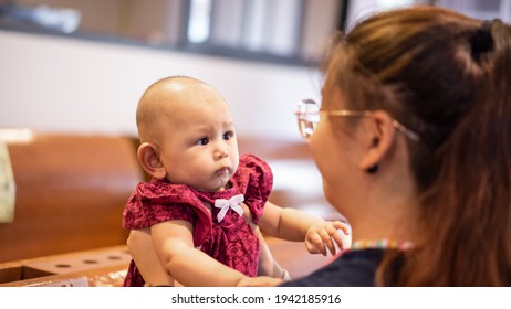 Baby Asian Girl Reaches For Adults Face Grasping For Anything Sh