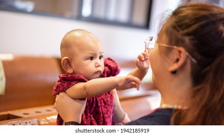 Baby Asian Girl Reaches For Adults Face Grasping For Anything Sh