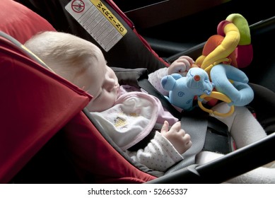 Baby Asleep In The Car, In A Safety Seat