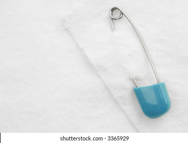 Baby Background - White Cotton Diaper Held Together With A Blue Safety Pin