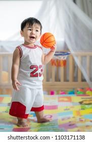 Baby with ball in basketball uniform, this immage can use for play, sport, baby, child, kid and exercise work
