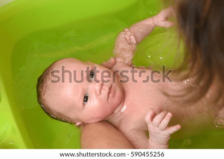 Similar – Image, Stock Photo Newborn in the bathtub held by her mother